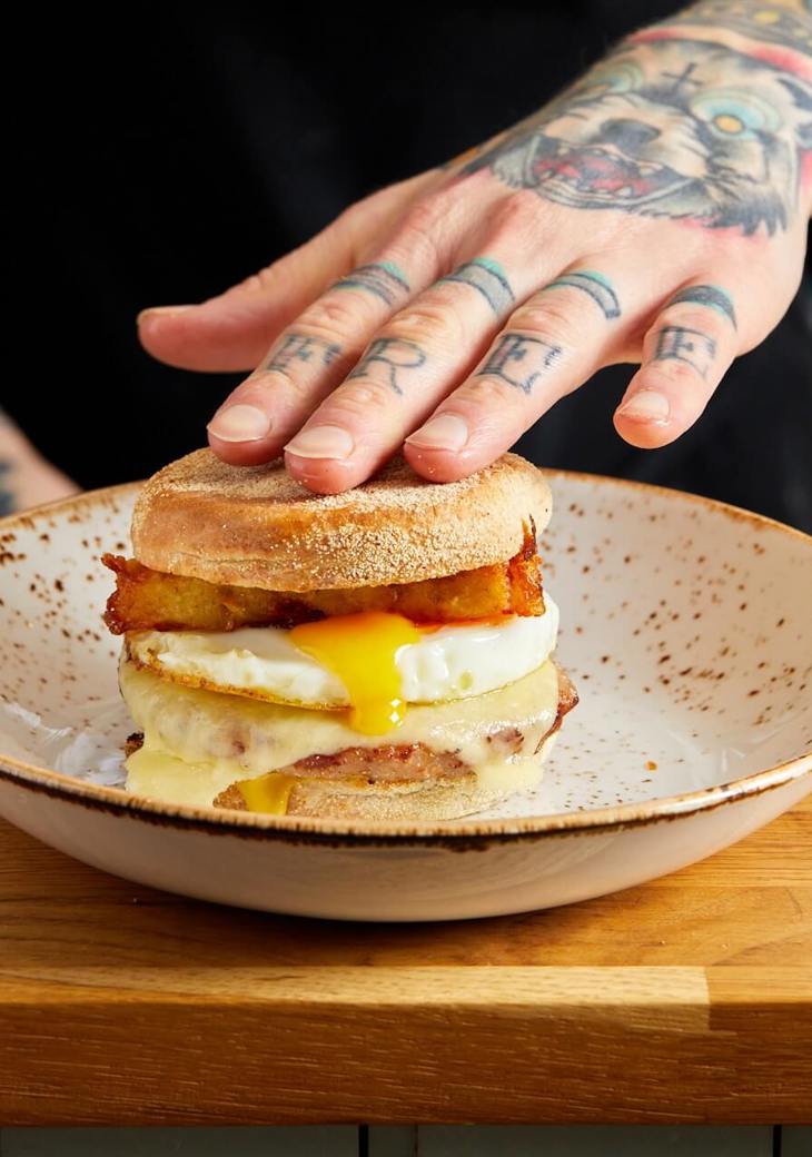 Our signature Sausage breakfast muffin. Sausage patty, melted cheese, runny fried egg and homemade hash browns