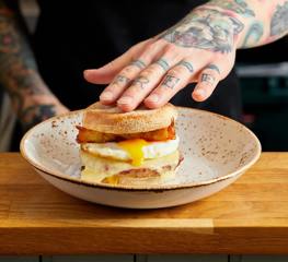 Our signature Sausage breakfast muffin. Sausage patty, melted cheese, runny fried egg and homemade hash browns