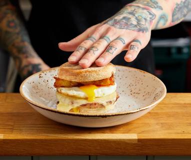 Our signature Sausage breakfast muffin. Sausage patty, melted cheese, runny fried egg and homemade hash browns