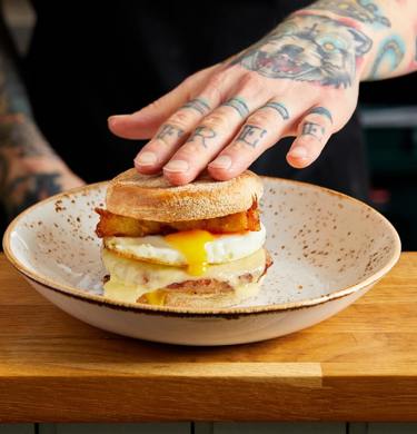 Our signature Sausage breakfast muffin. Sausage patty, melted cheese, runny fried egg and homemade hash browns