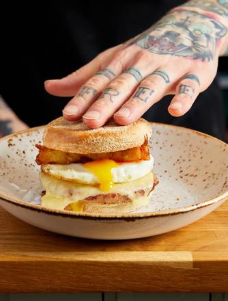 Our signature Sausage breakfast muffin. Sausage patty, melted cheese, runny fried egg and homemade hash browns
