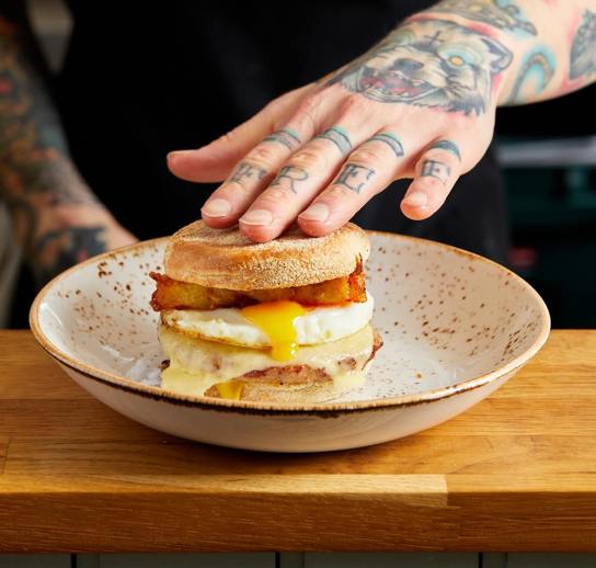 Our signature Sausage breakfast muffin. Sausage patty, melted cheese, runny fried egg and homemade hash browns